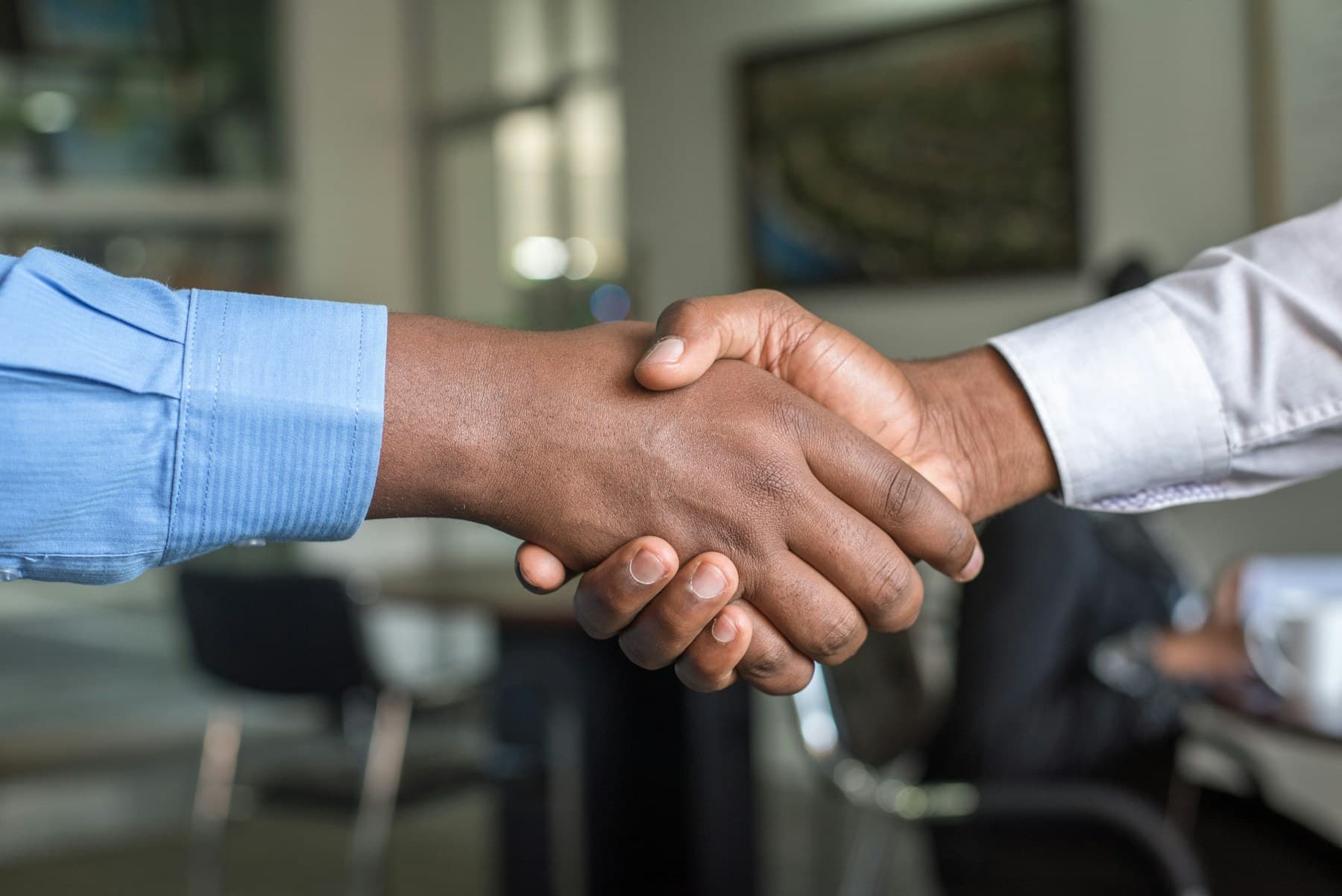Professional handshake over a documented engagement